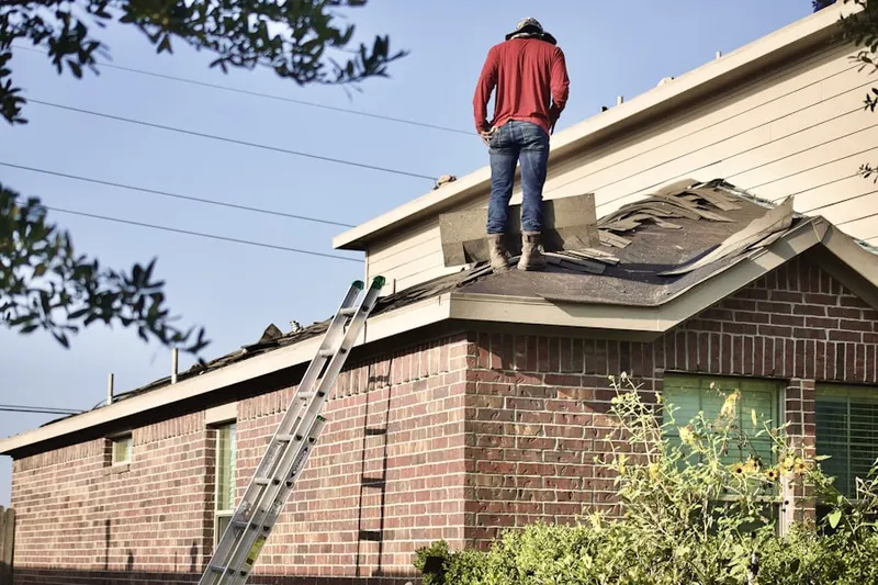 Professional roofer working on a residential roof in South Main